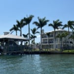 Huge home with great palms and a nice boat house out back.